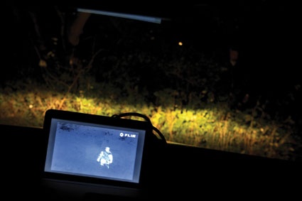 The high contrast thermal footage is displayed on a TFT screen on the dashboard.