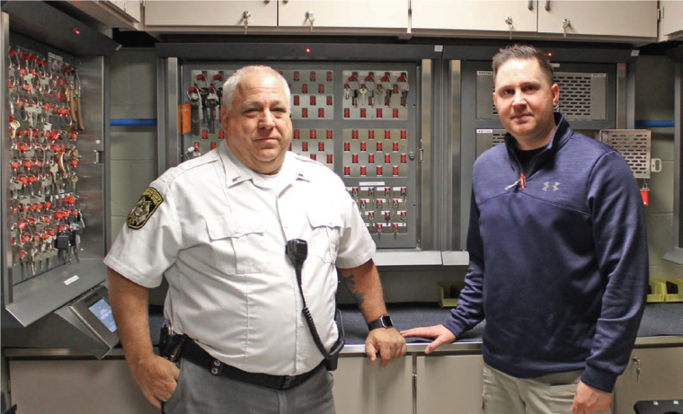 Lt. John Hickey and Sgt. Keith Price in front of one of the KeyWatcher systems...