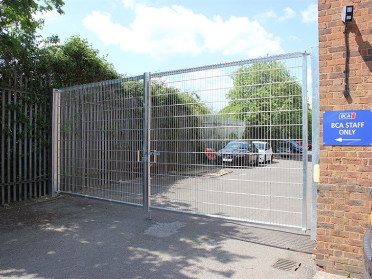 Vertical bar fencing replaces steel palisade to provide perimeter security for...