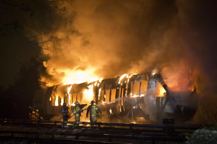 A burning passenger rail car near Berlin in Germany. Although no-one was hurt,...