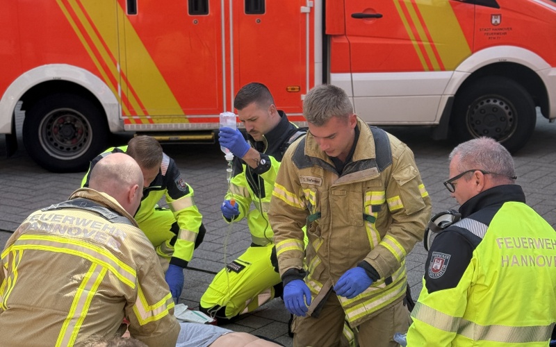 Einsatzkräfte der Feuerwehr Hannover in Übungssituation rund um eine Übungspuppe