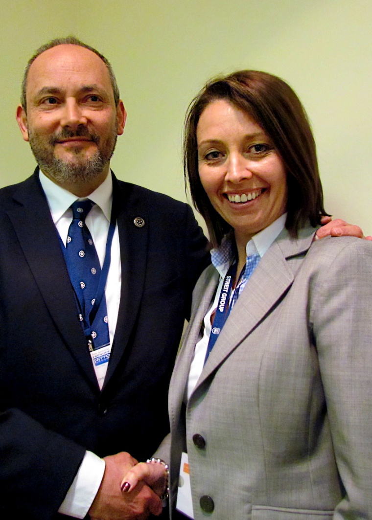 Outgoing Chairman, Mike Bluestone, congratulates Emma Shaw on her appointment...