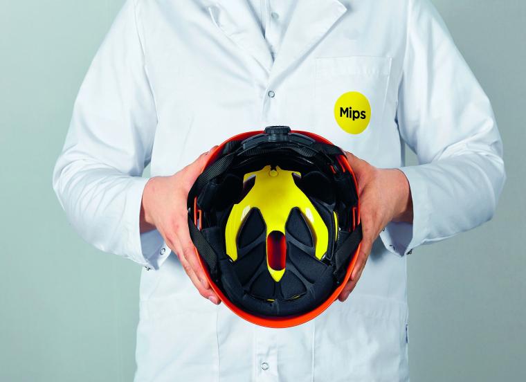 A protective helmet fitted with the Mips safety system (yellow).