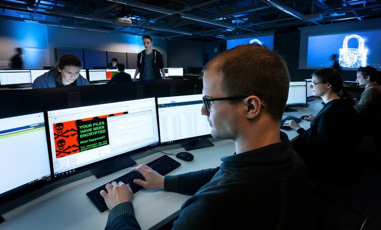 Blick über die Schulter eines Teilnehmers eines Cybertrainings. Vor ihm...