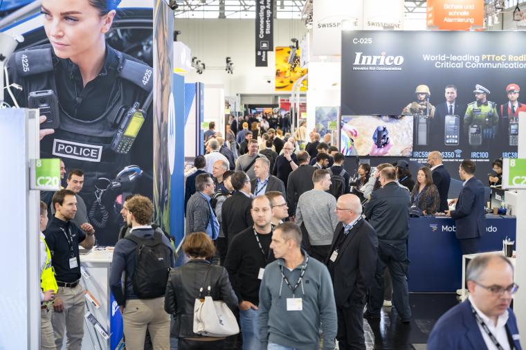 The picture shows a busy exhibition hall with numerous visitors gathering...