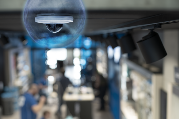 A dome camera affixed to the ceiling of an industrial