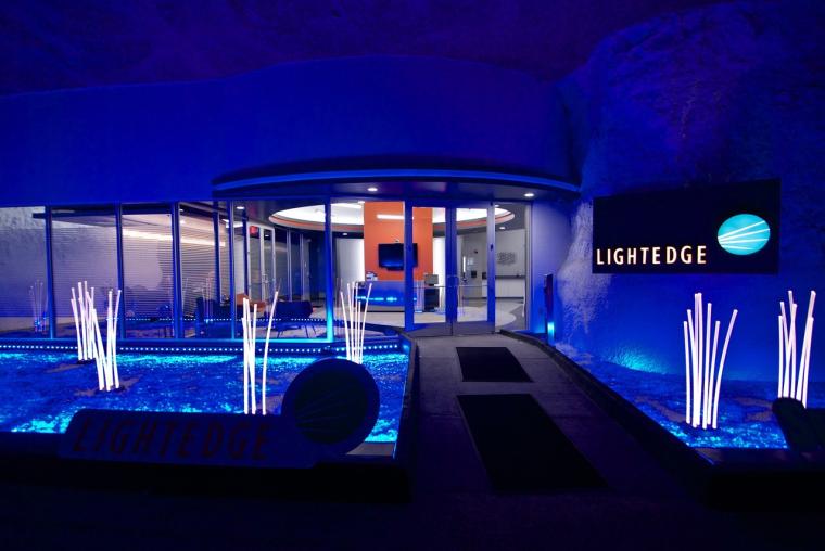 Night view of the LightEdge building entrance with blue lighting, glass...