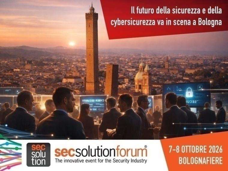 Geschäftsleute vor Monitoren – im Hintergrund die Stadt Bologna im Abendlicht
