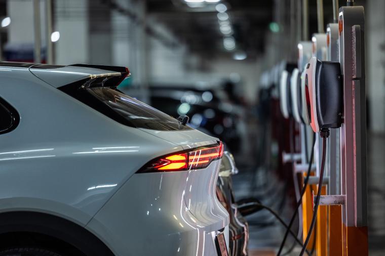 Autonomous EV car charging at AC power station. Self driving vehicle