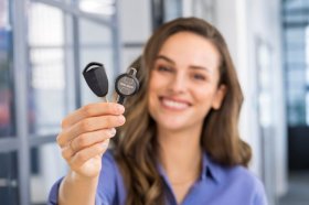 Person holding two programmable digital access keys for secure entry control.